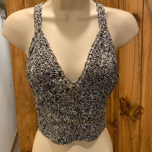 Knit crop top. Tie back closure.